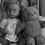 broken doll and scruffy teddy bear