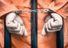 prisoners hands handcuffed through bars