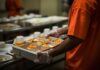 Prisoner with tray of prison food