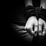 Human trafficking. Hands bound together,