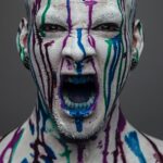 screaming man covered in paint