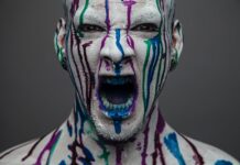 screaming man covered in paint