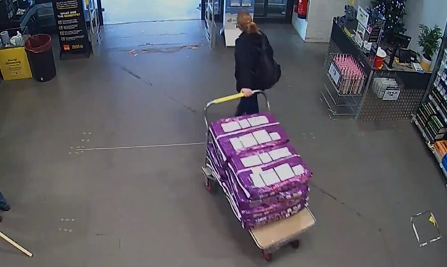 Fiona Beal pulling trolly with bags of compost and stone leaving B&Q in Northampton.